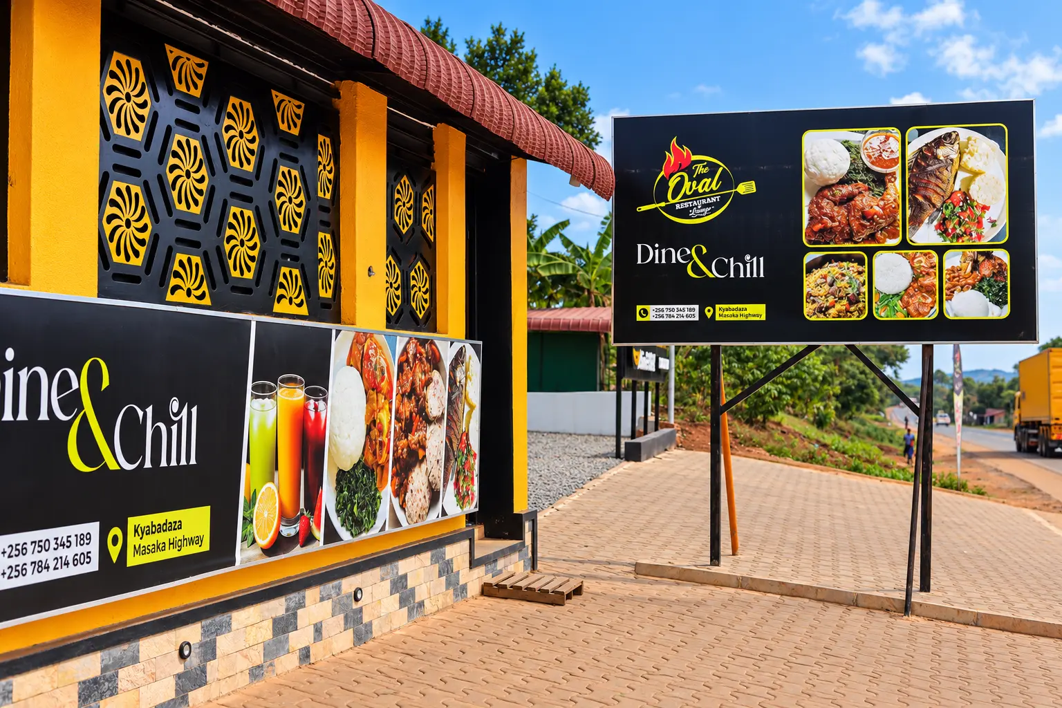 The Oval Restaurant & Lounge black and gold frontage with roadside billboard on Kyabadaza, Masaka Highway