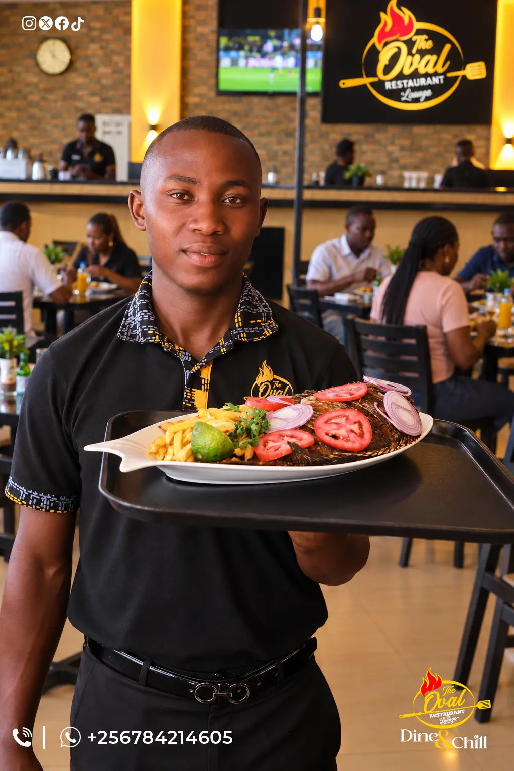 Oval waiter serving a plate of whole fried fish with chips and salad in the dining room